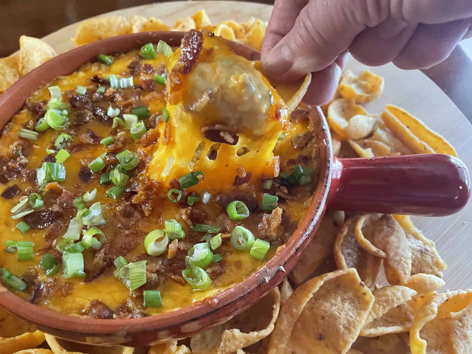 Baked Cheddar, Bacon and Chutney Dip -- dipping chip in dip