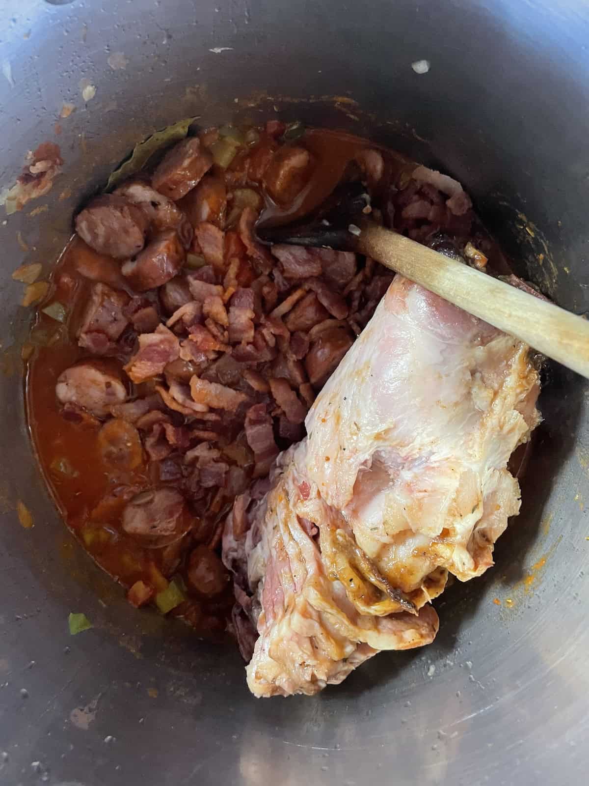 Pinto Bean Soup with Ham and Andouille -- adding bacon and sausage back to pot along with hambone