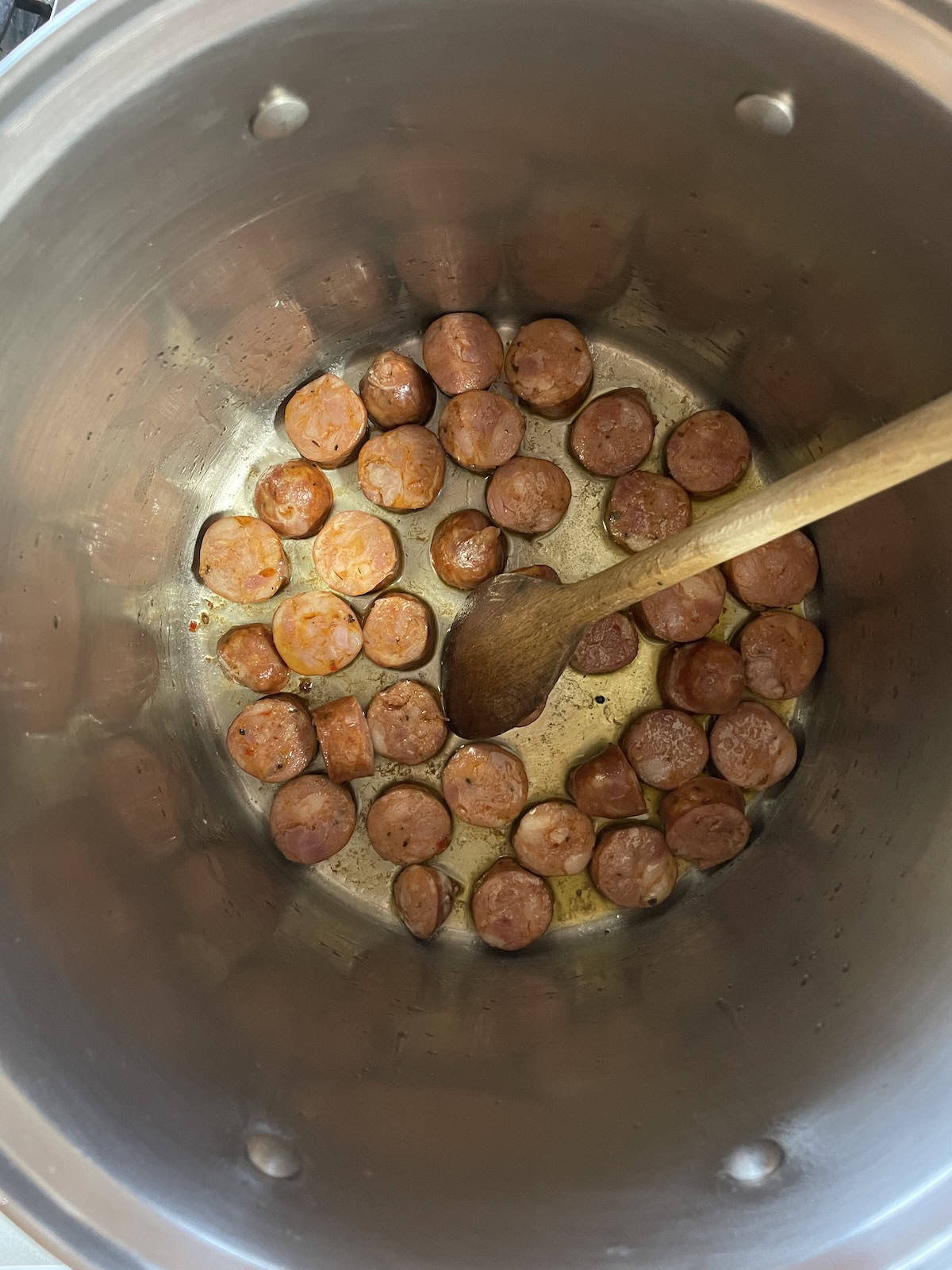 Pinto Bean Soup with Ham and Andouille sautéing andouille sausage