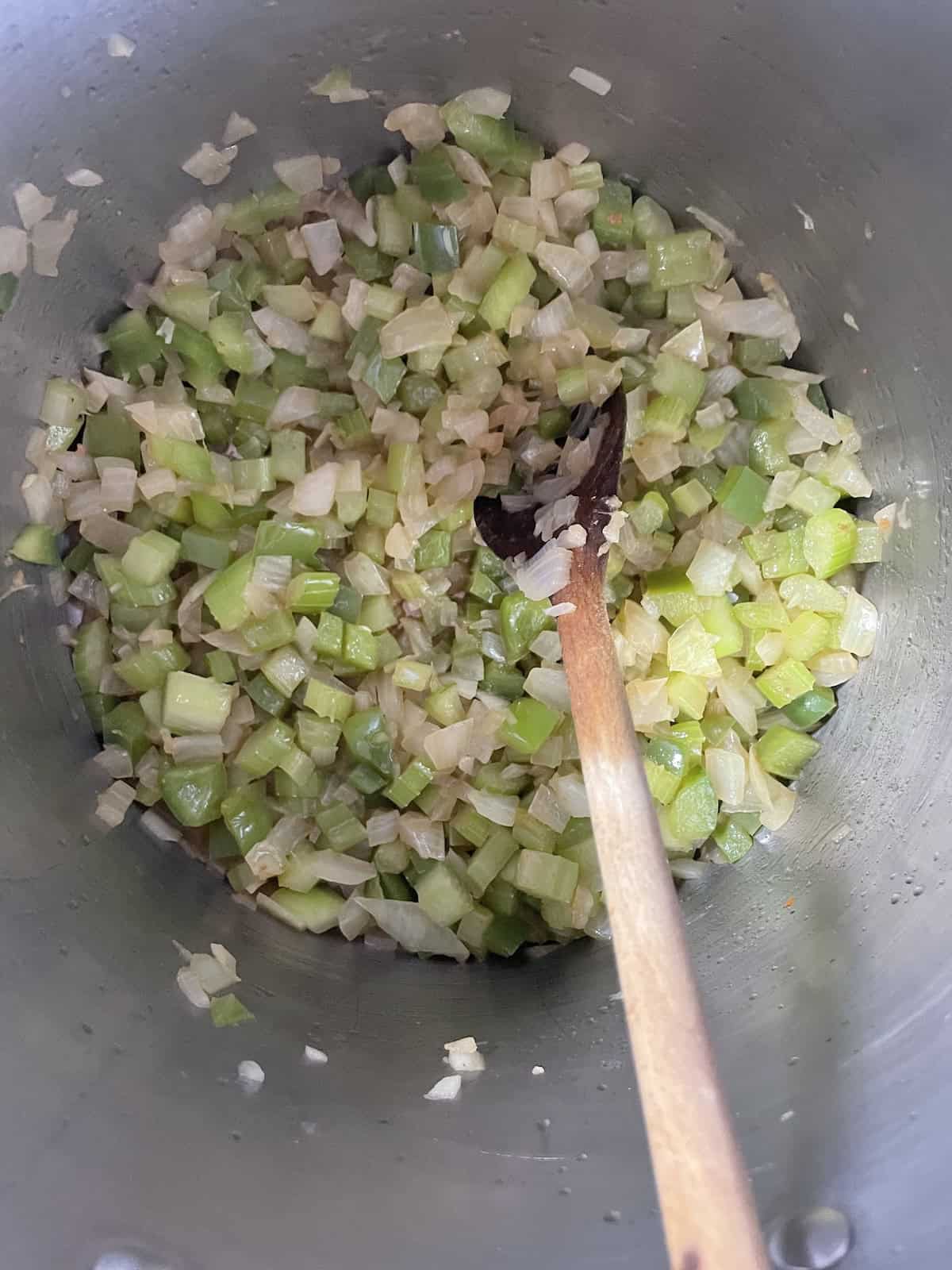 Pinto Bean Soup with Ham and Andouille sautéing onions, celery and green pepper