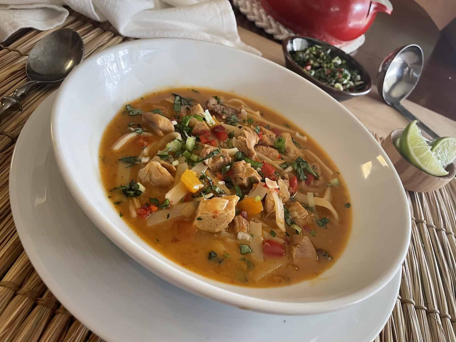 Tom Kha | Thai Red Curry Turkey Soup -- in a serving bowl with garnishes