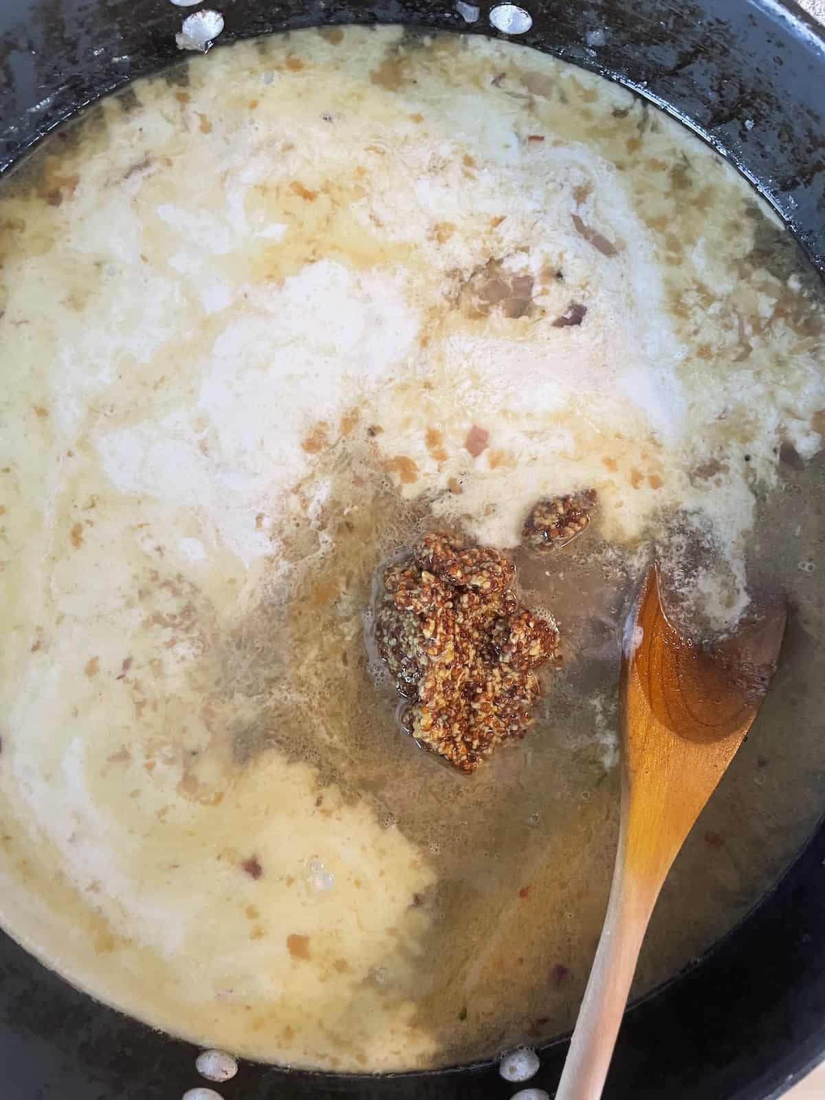 Adding cream and chicken stock