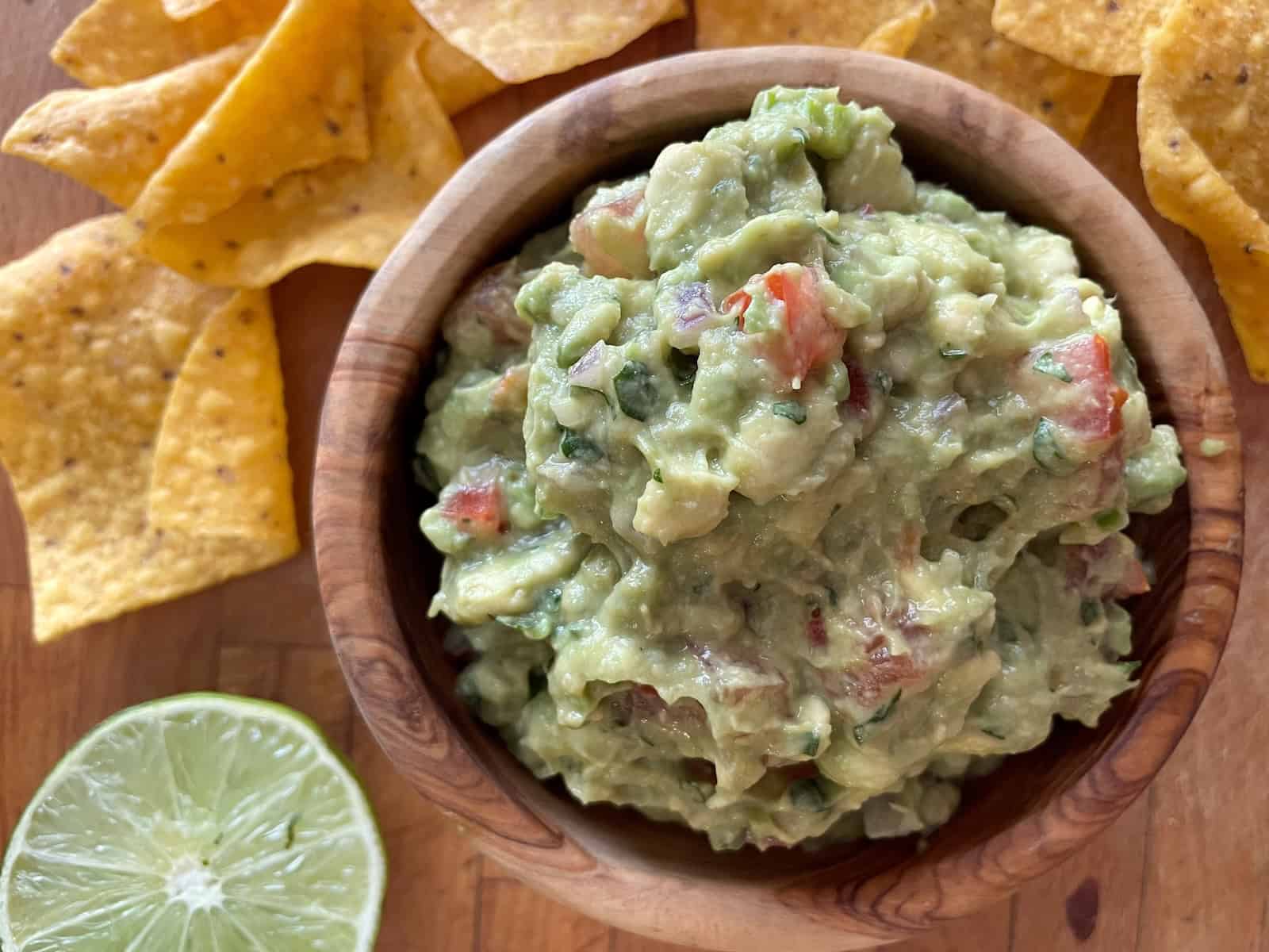 Guacamole in serving dish with chips