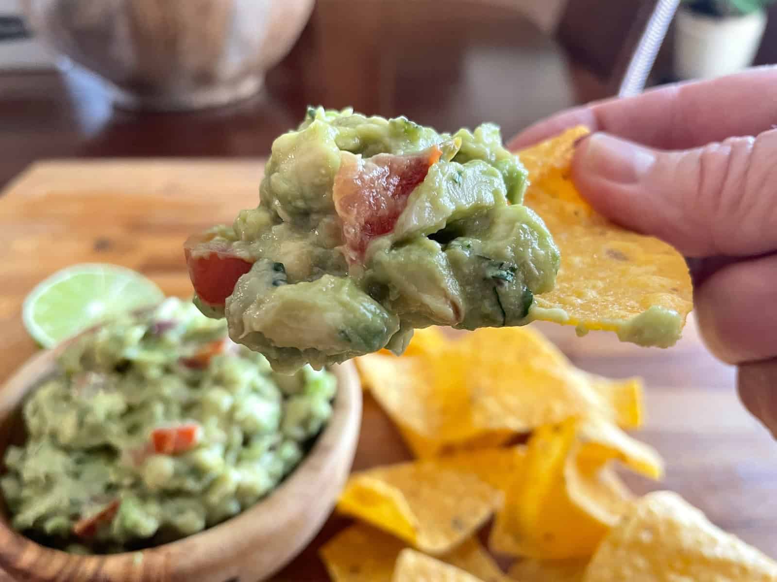 Asian guacamole being dipped onto a chip