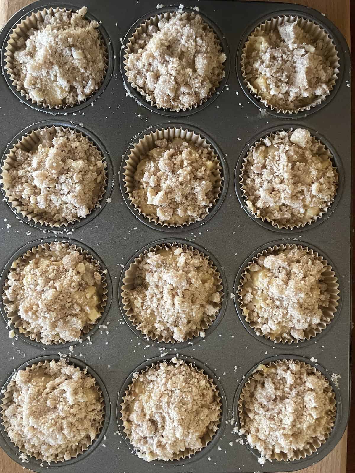 batter and topping in muffin tins