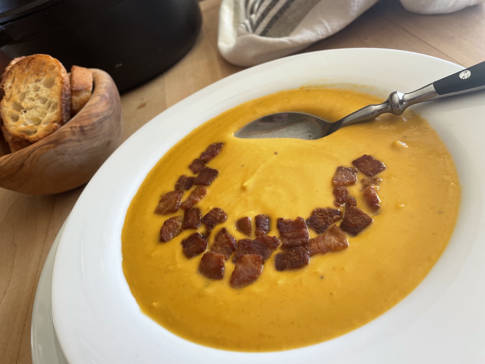 Butternut Squash Soup with Bacon and Brandy in a soup bowl