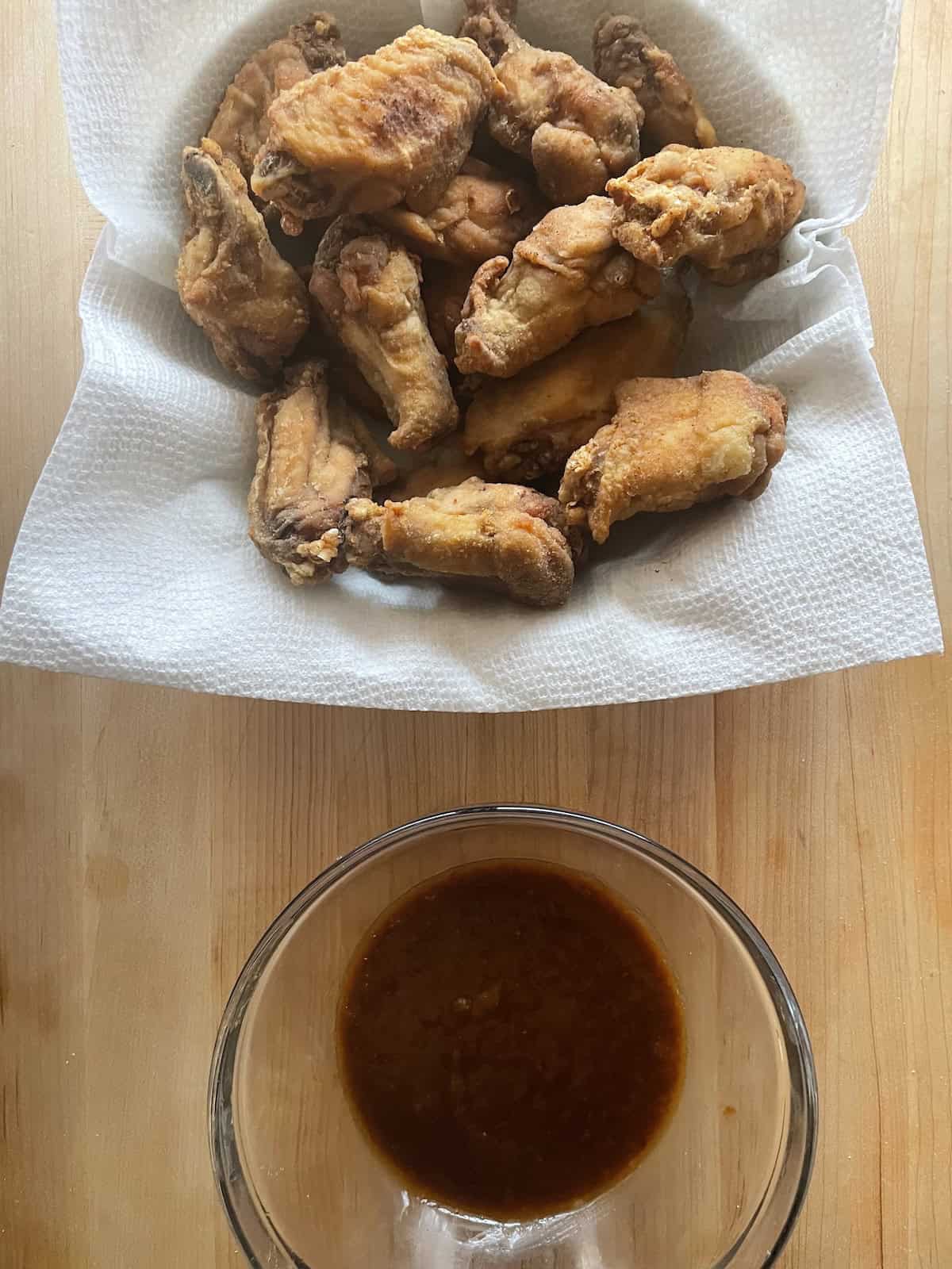 Polynesian Chicken Wings with Pineapple Mustard Sauce - wings getting ready to be dipped in wing sauce