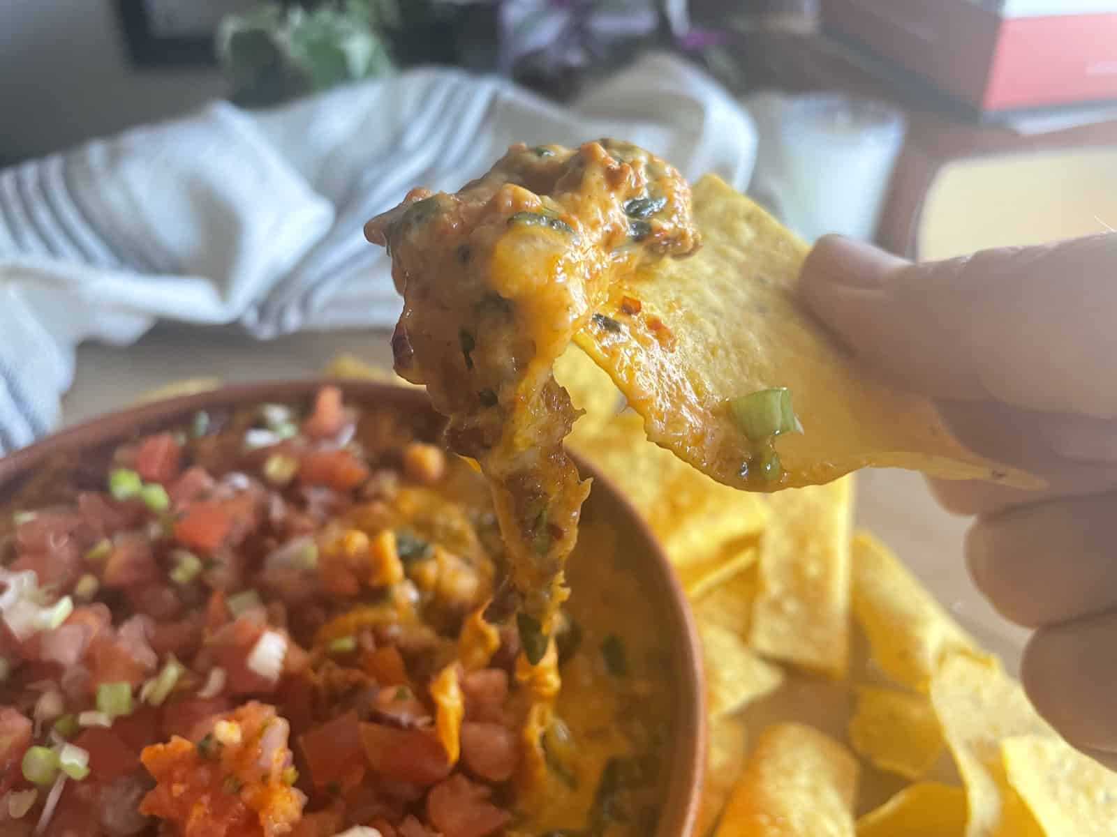 Queso Fundido with Chorizo dipping a chip