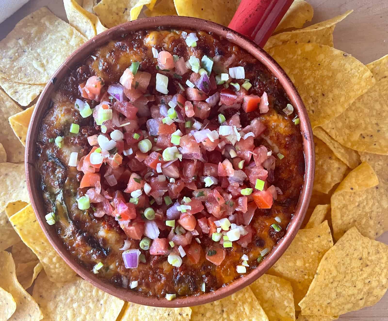 Queso Fundido with Chorizo overhead photo of baked dish with chips