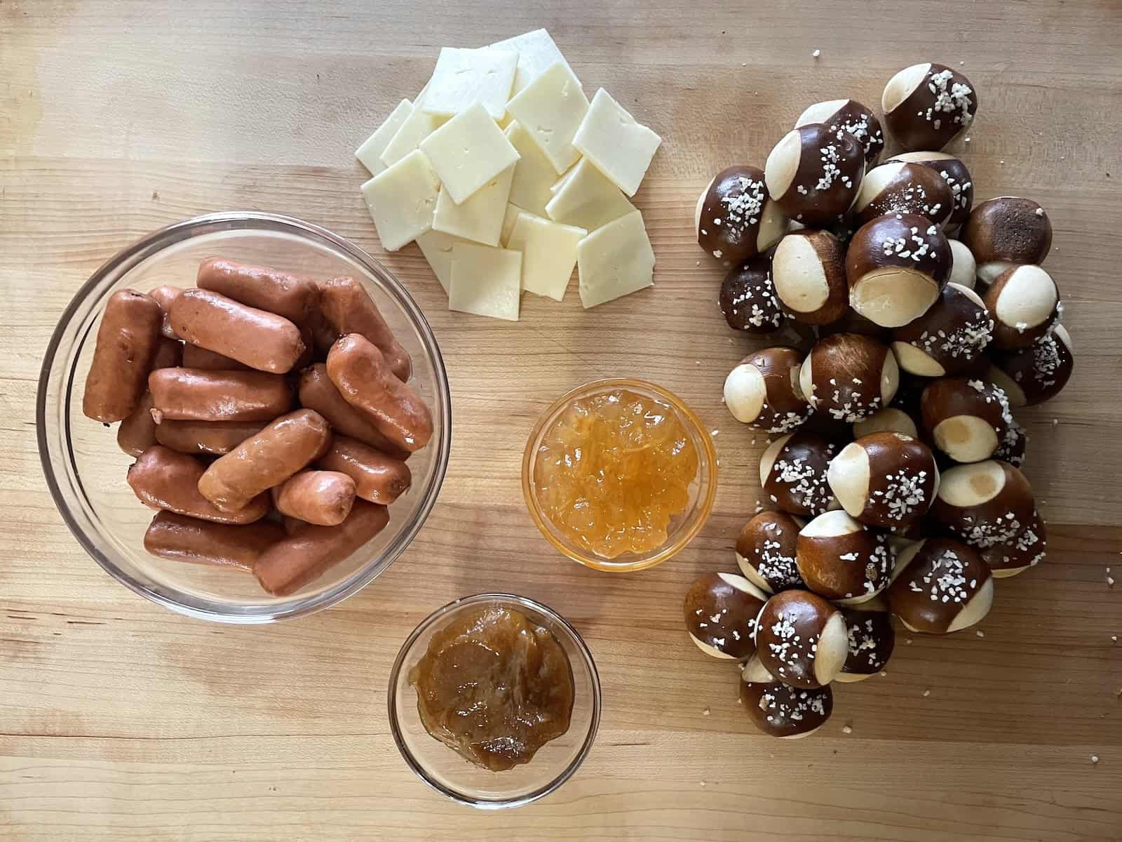 Little Smokie Pretzel Bites with Honey Mustard and Apple Jelly ingredients on a work space