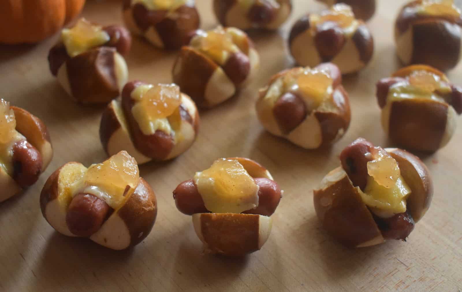 Little Smokie Pretzel Bites with Honey Mustard and Apple Jelly on a serving board