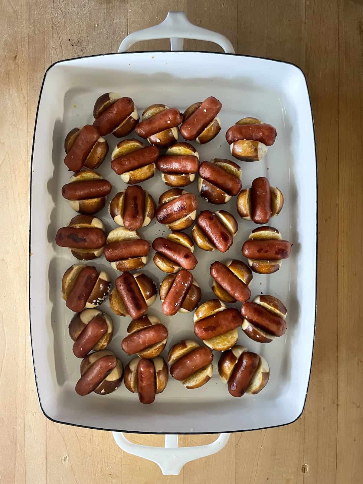 Little Smokie Pretzel Bites with Honey Mustard and Apple Jelly in baking dish