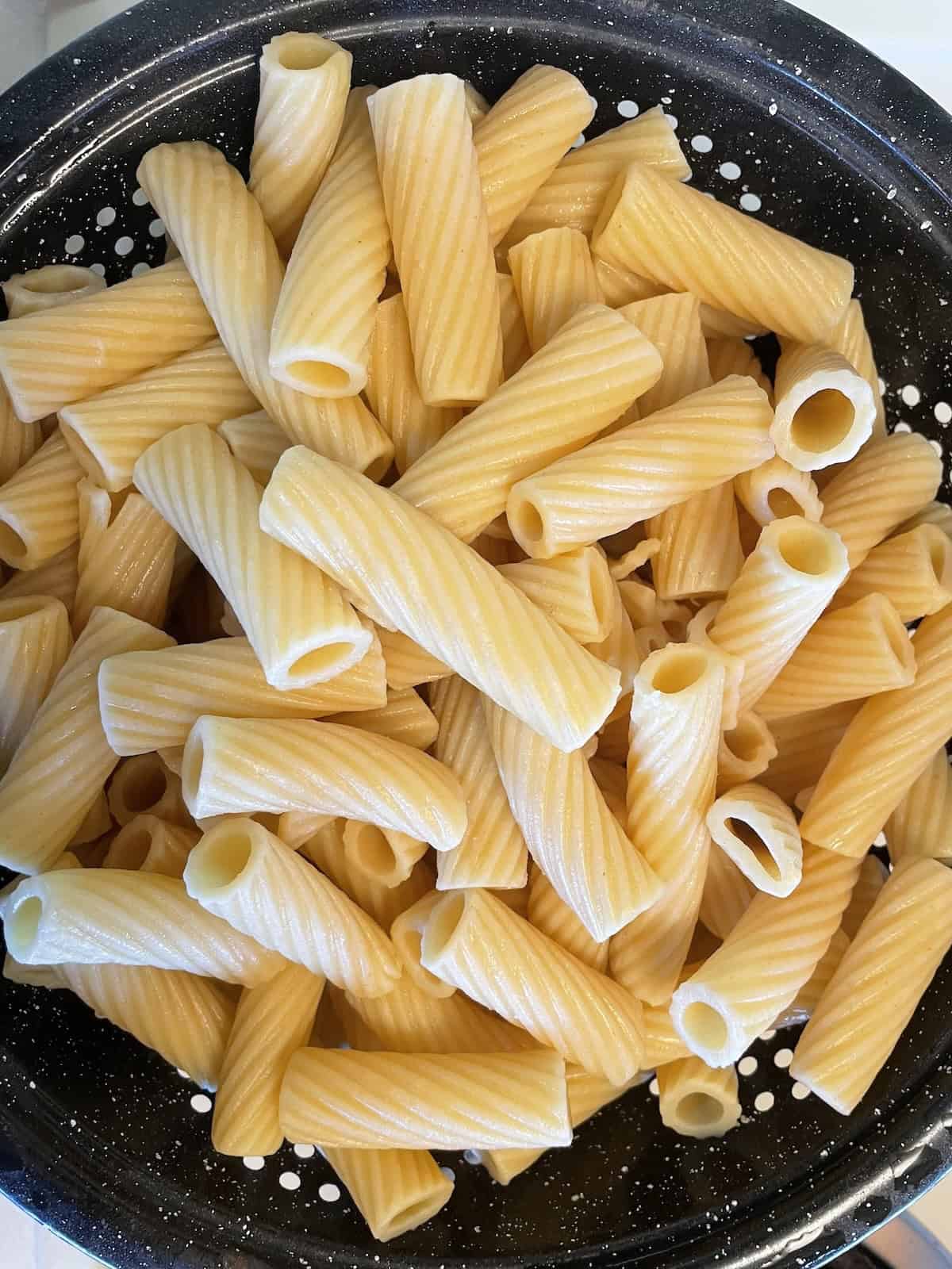 Sausage and Mushroom Rigatoni with Marsala and Parmesan -- cooked pasta draining