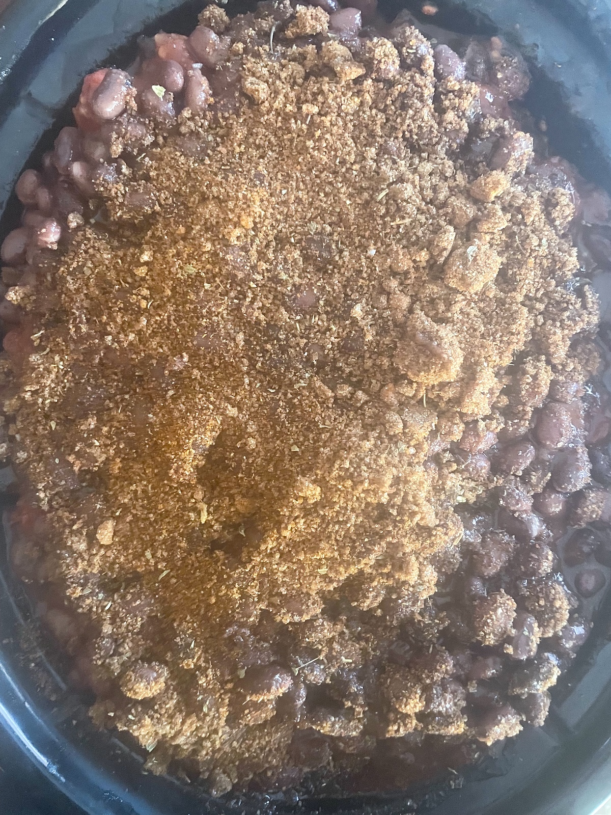 spice mixture over beans and tomoatoes