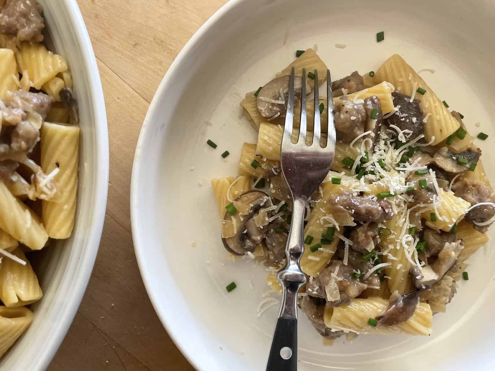 Sausage and Mushroom Rigatoni with Marsala and Parmesan in a serving bowl