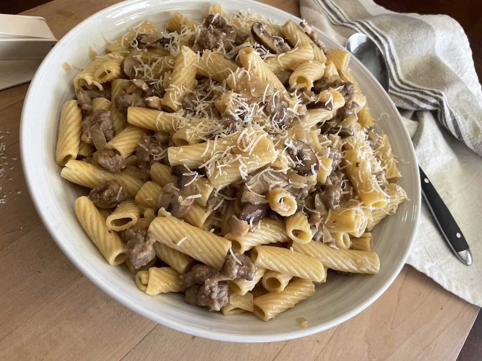 Sausage and Mushroom Rigatoni with Marsala and Parmesan in a serving bowl