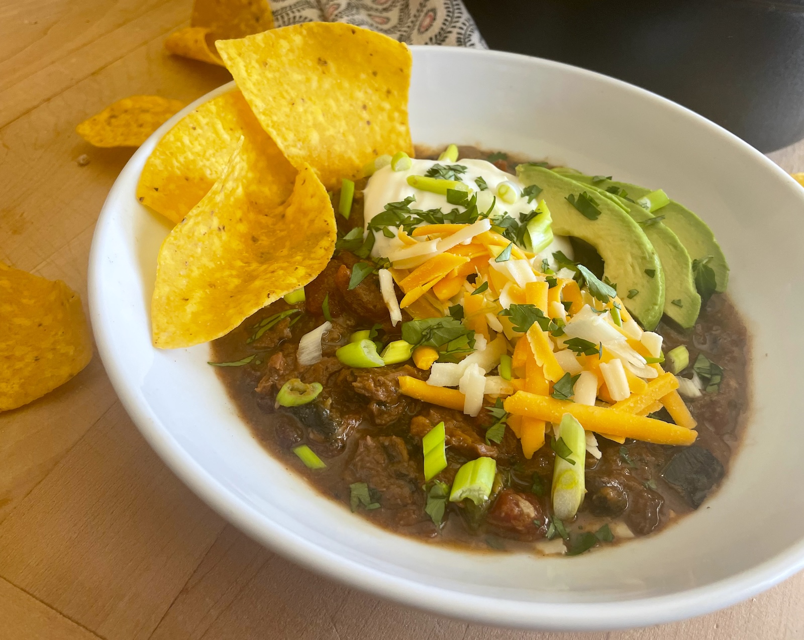 Slow Cooker Short Rib Mole Chili with Poblanos and Butternut Squash in a bowl with garnishes  