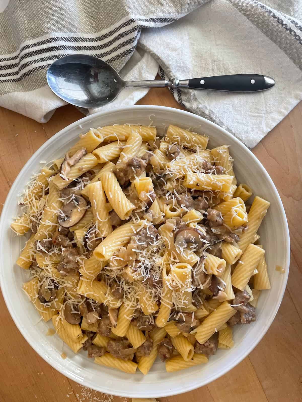 Sausage and Mushroom Rigatoni with Marsala and Parmesan in a serving bowl