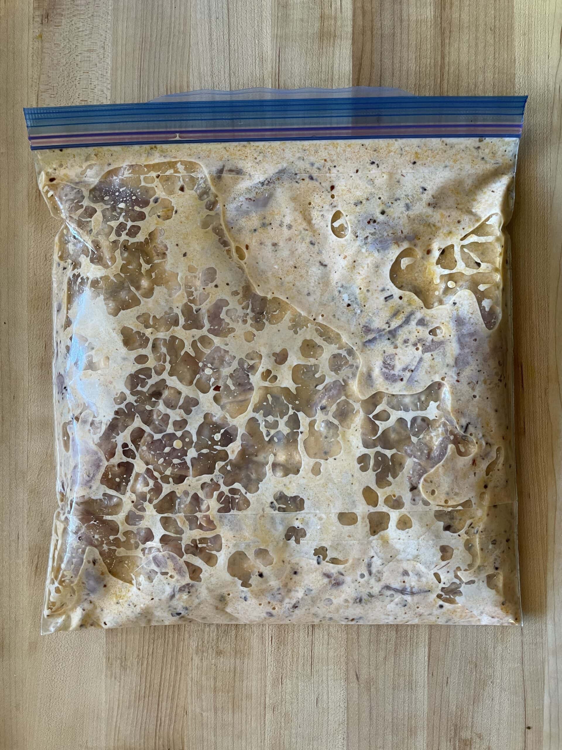 chicken marinading in a bag