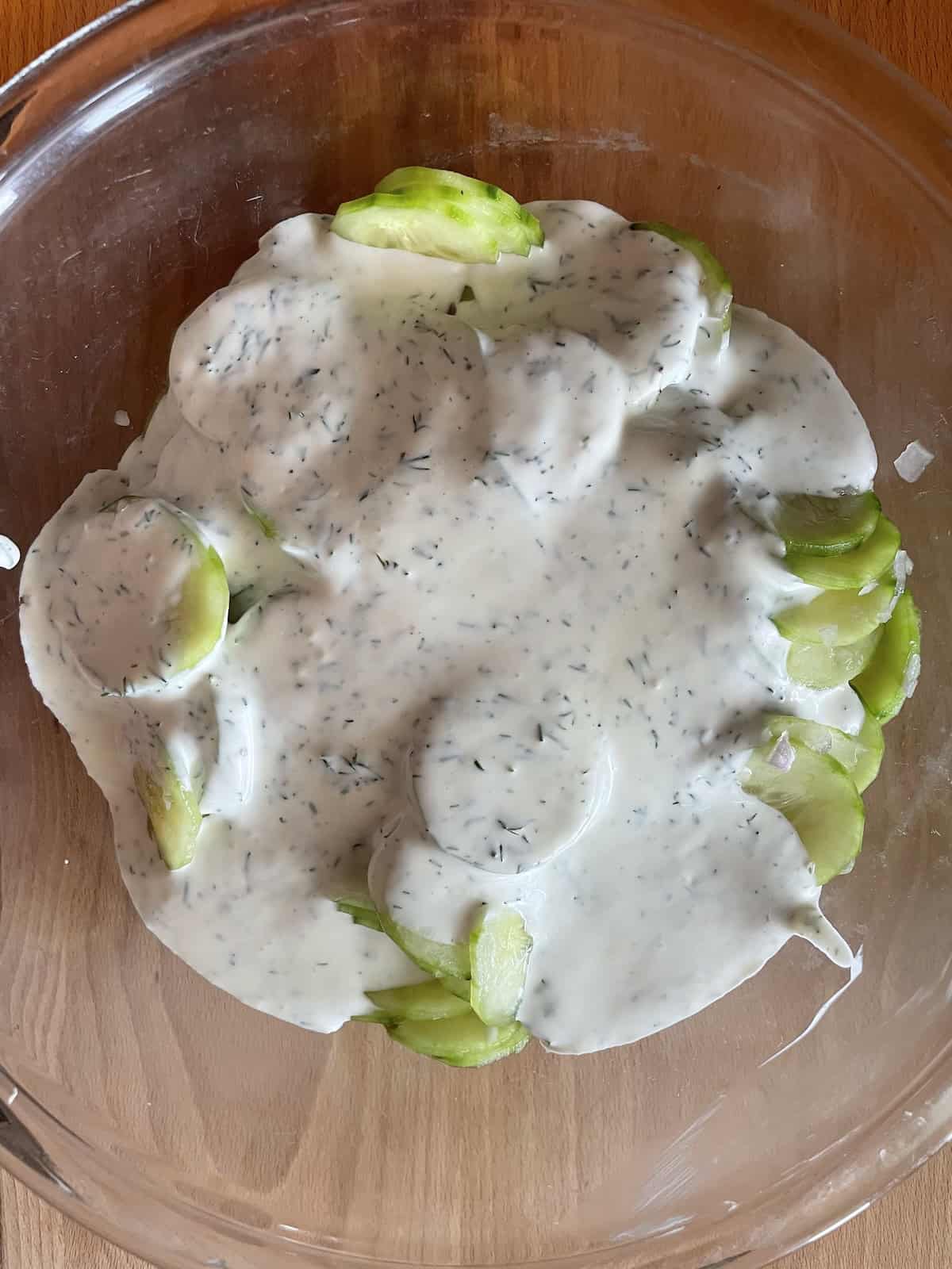 dressing a cucumbers combined in a bowl