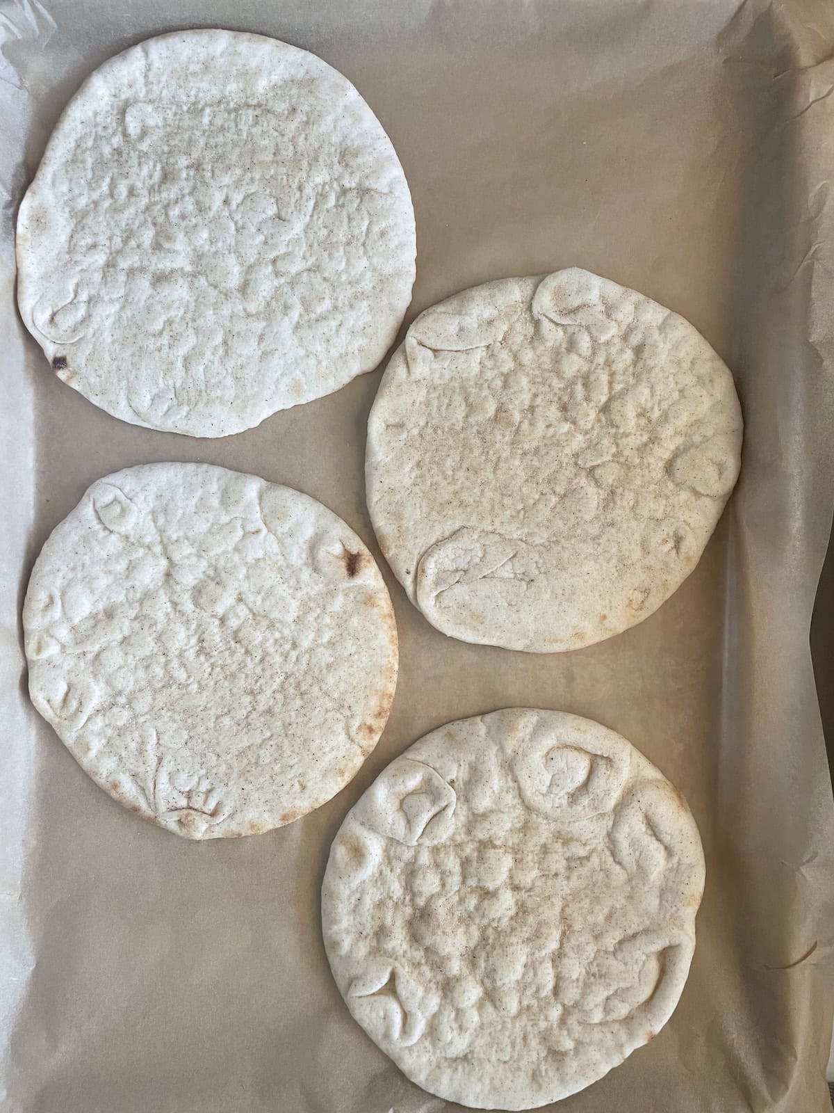pita bread on a baking sheet