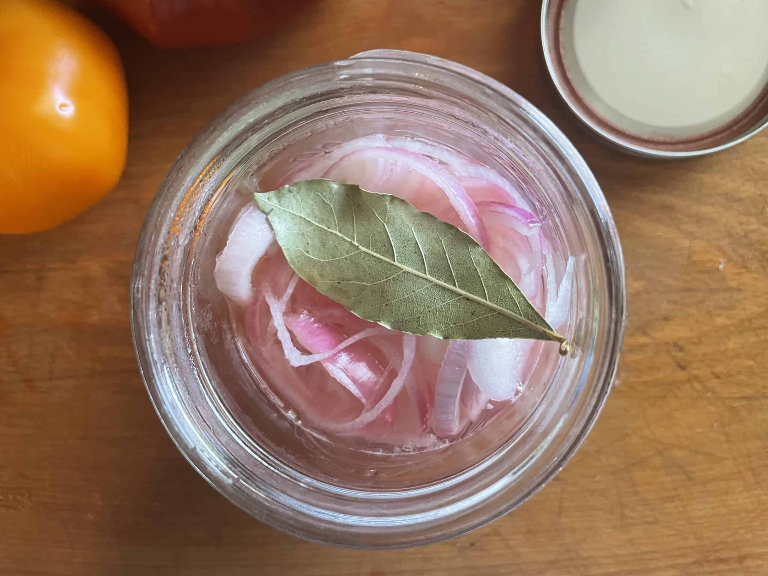 ingredients in a jar with bay leaf