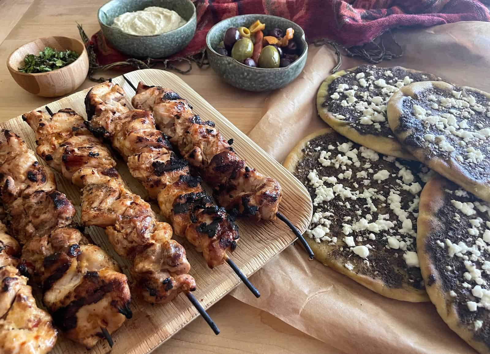 Yogurt, Harissa and Aleppo Pepper Chicken Kebabs with Za’atar and Feta Pita Bread served