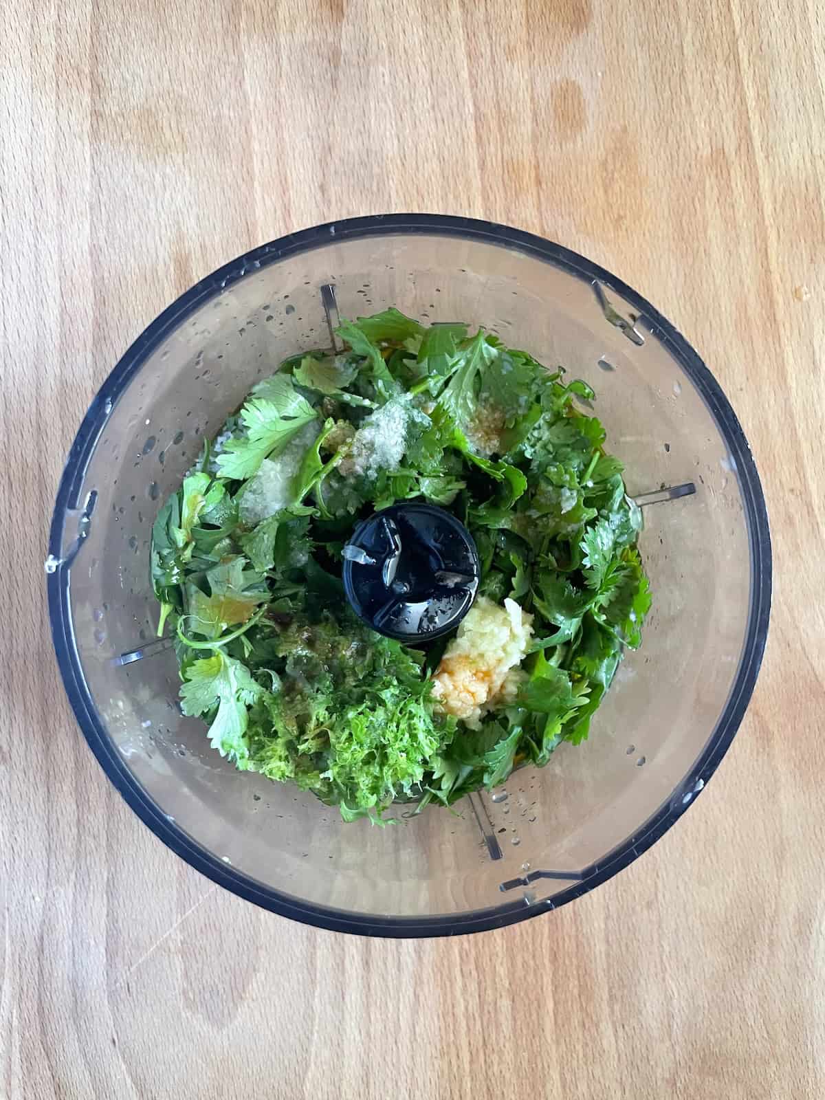 dressing ingredients on bowl of food processor