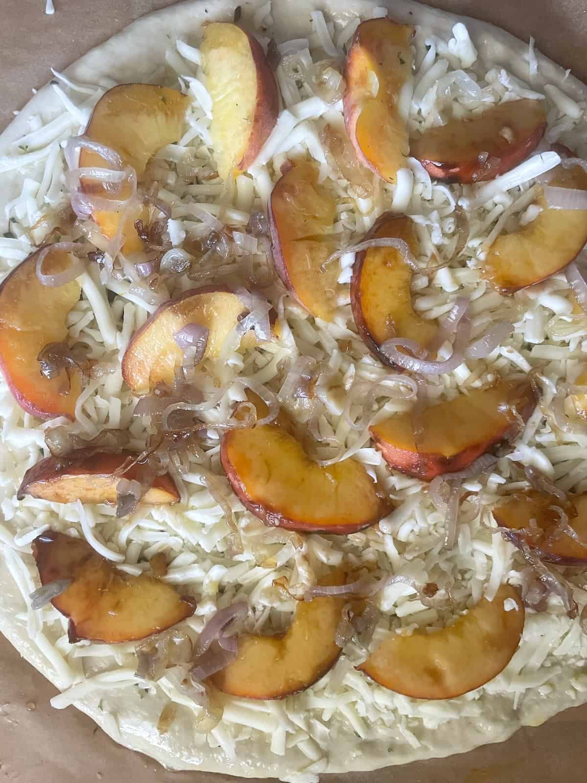 pizza crust topped with cheese and peaches