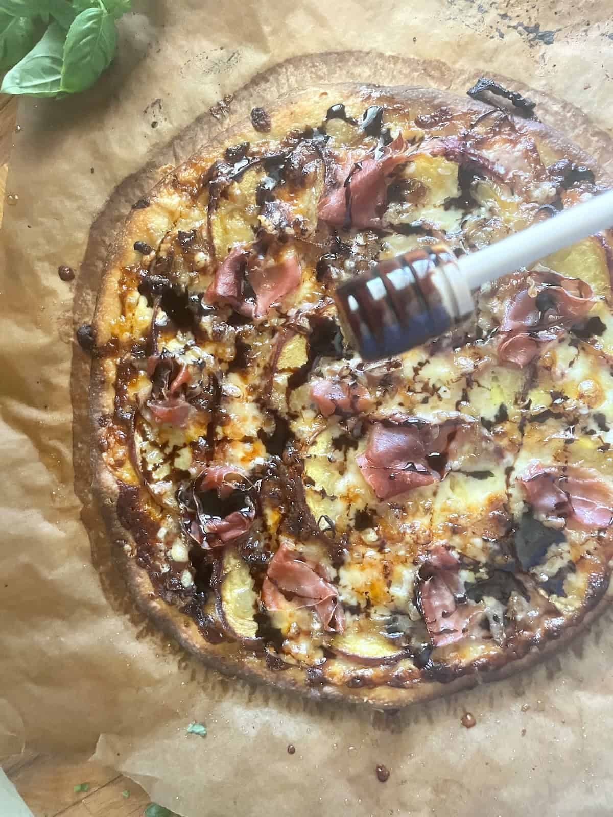 baked pizza drizzled with honey balsamic reduction
