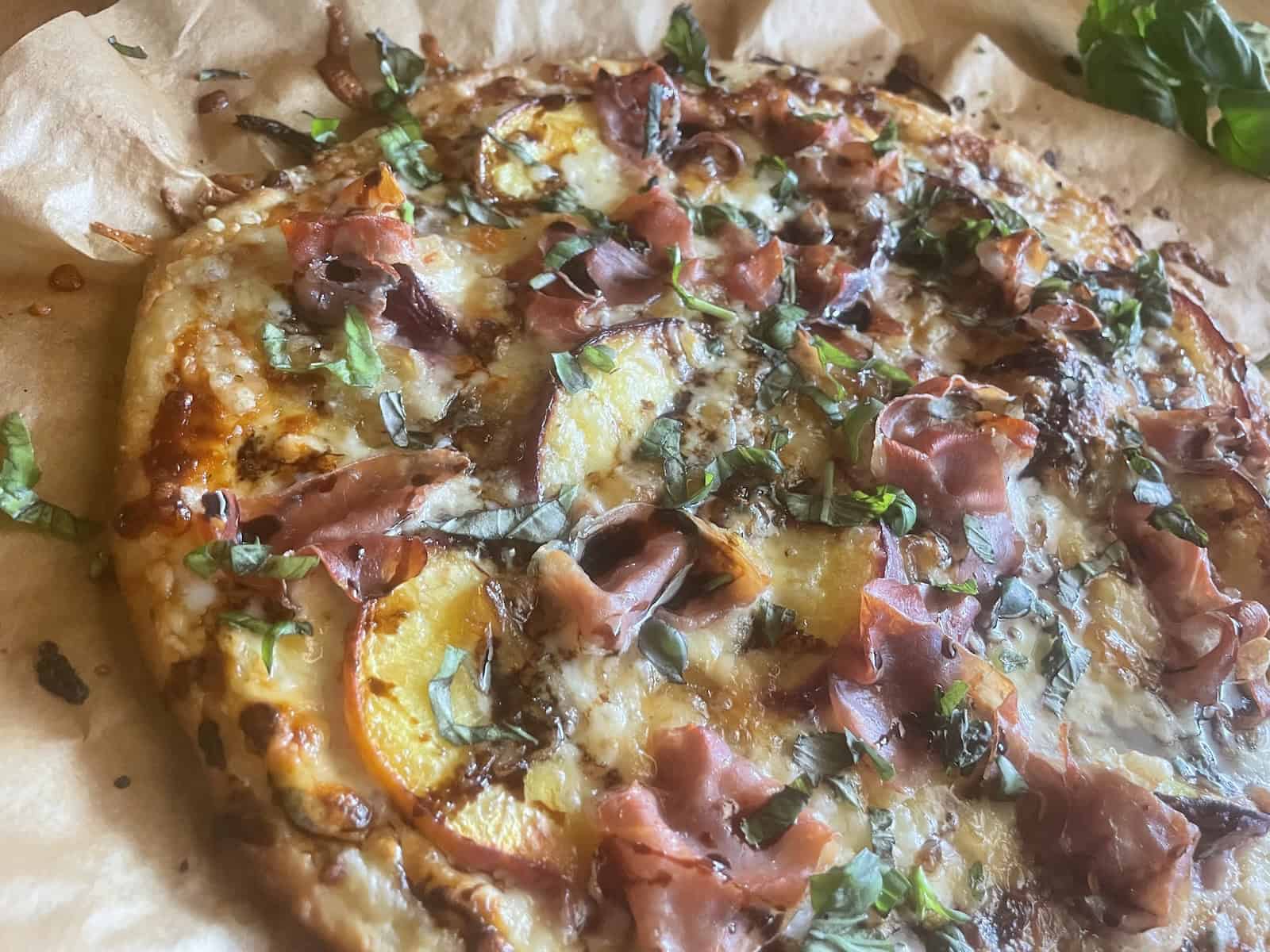 Peach and prosciutto pizza