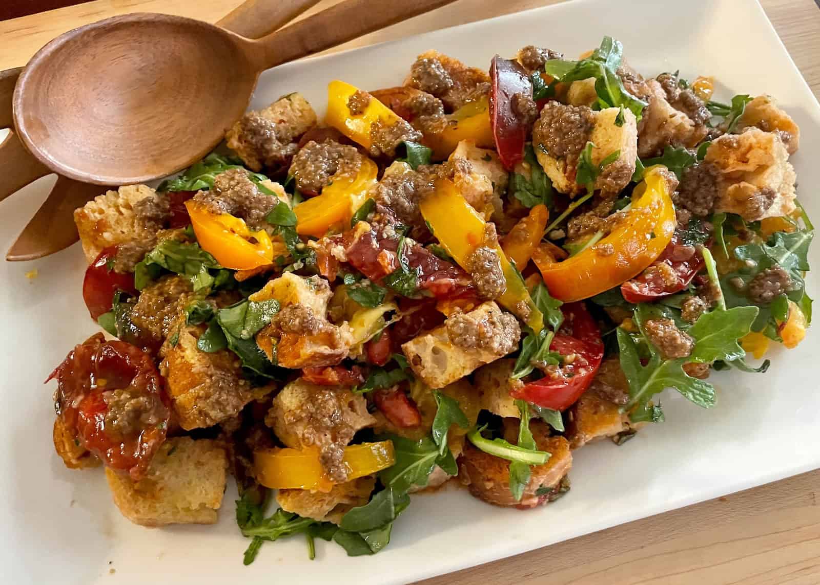 Marinated Tomato and Bread Salad with Olive, Orange and Za‘atar Dressing on a serving platter