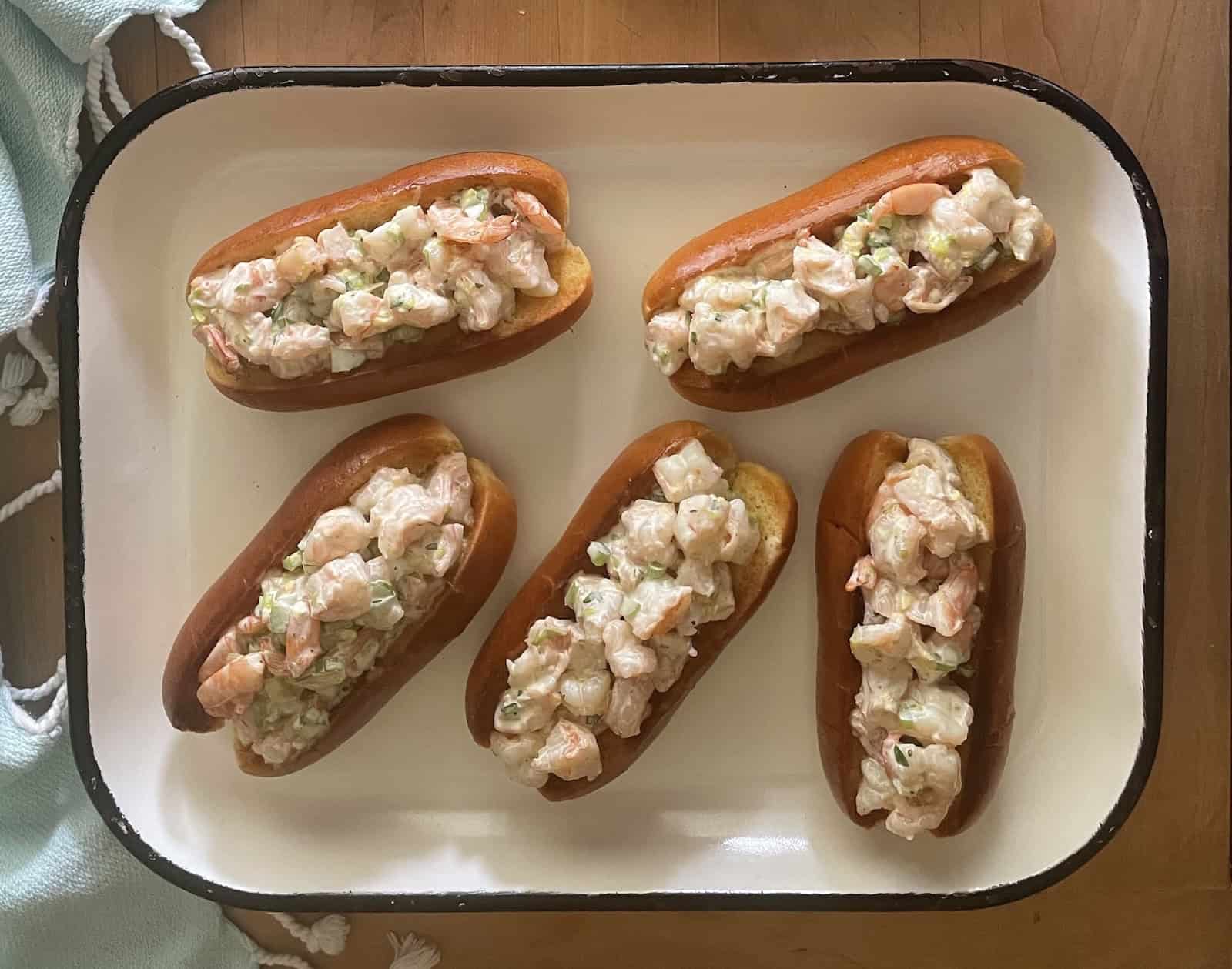 buns stuffed with shrimp on a platter