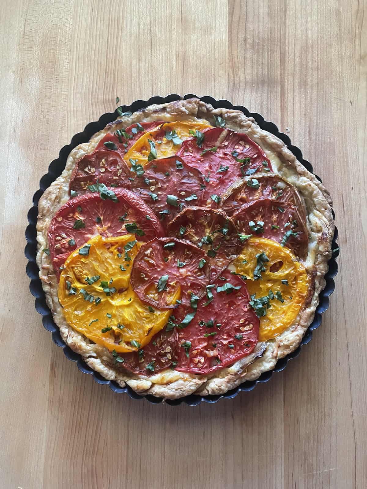 Tomato, Onion and Gruyere Tart baked and sprinkled with basil