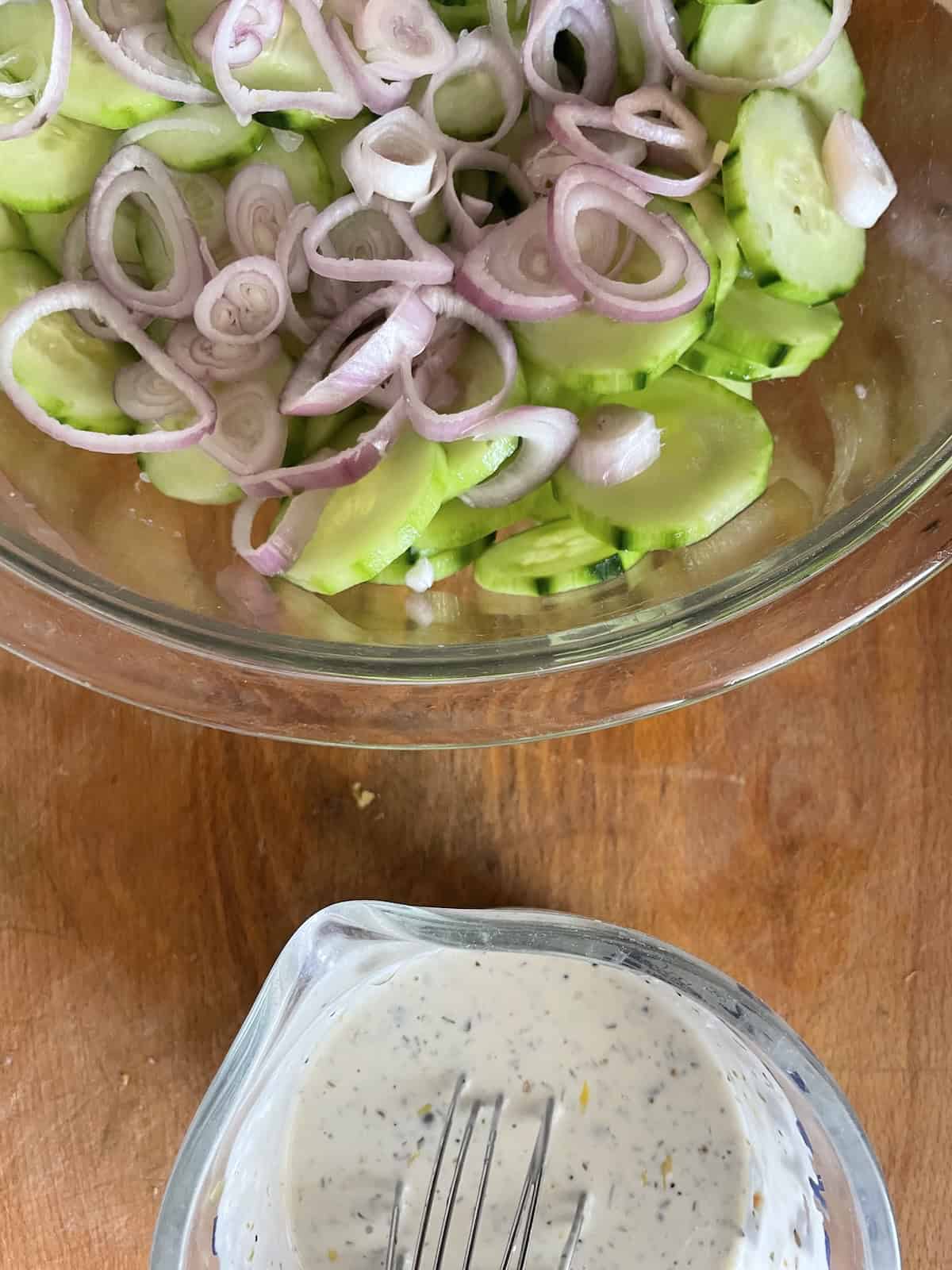 adding cucumbers to bowl