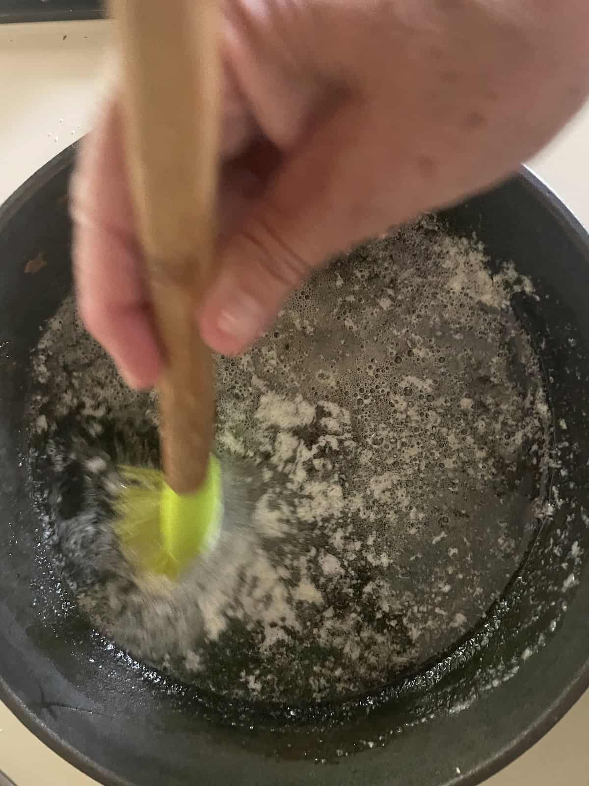 brushing butter up sides of skillet