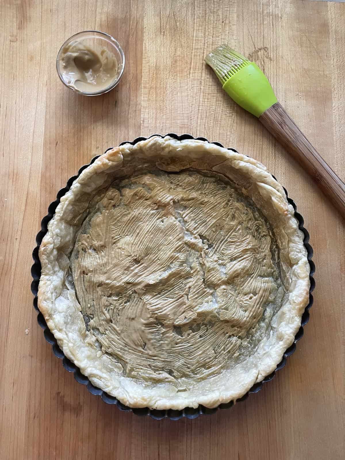 pastry shell brushed with dijon mustard