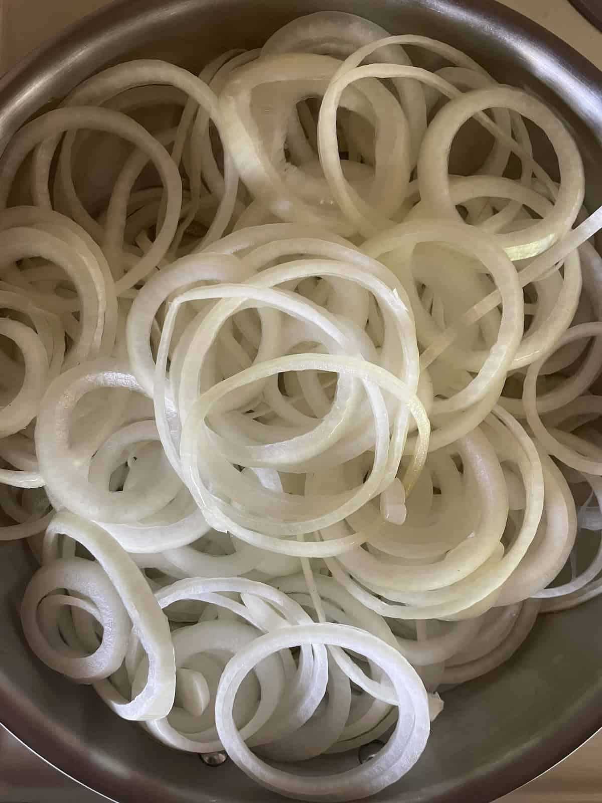 raw onions in skillet