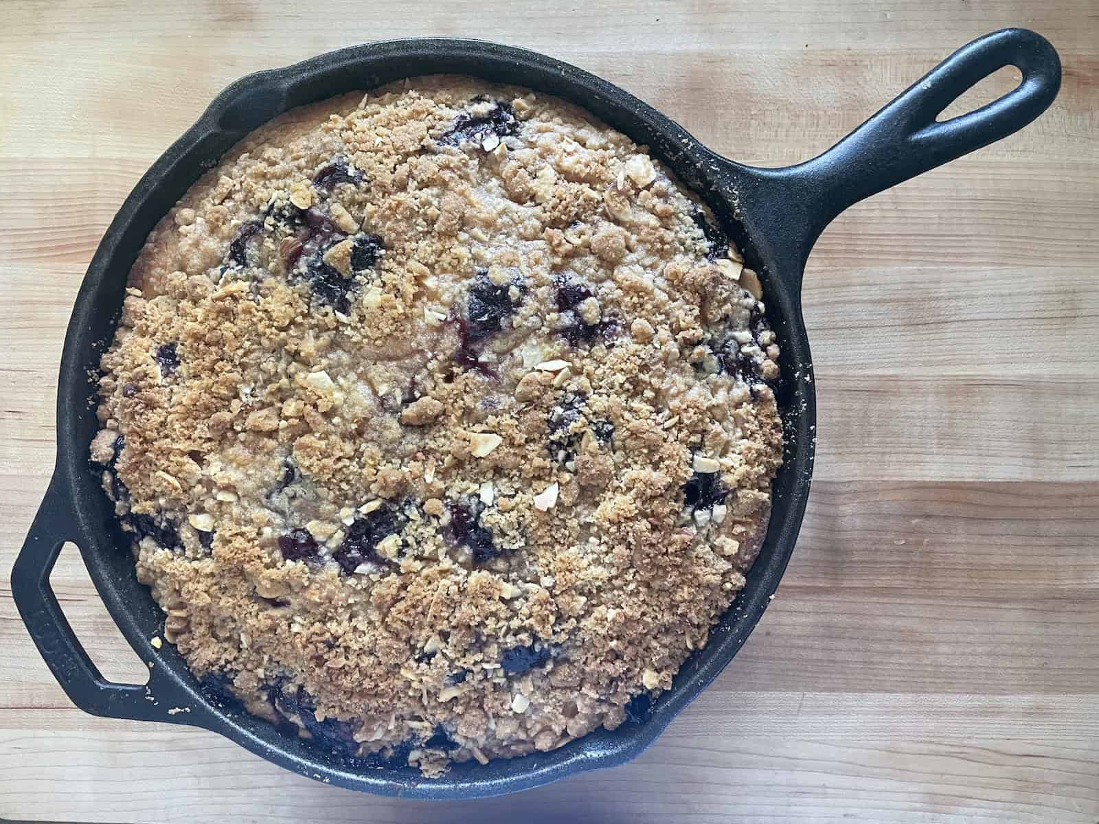 Peach and Blueberry Buttermilk Buckle with Almond Streusel in cast iron skillet