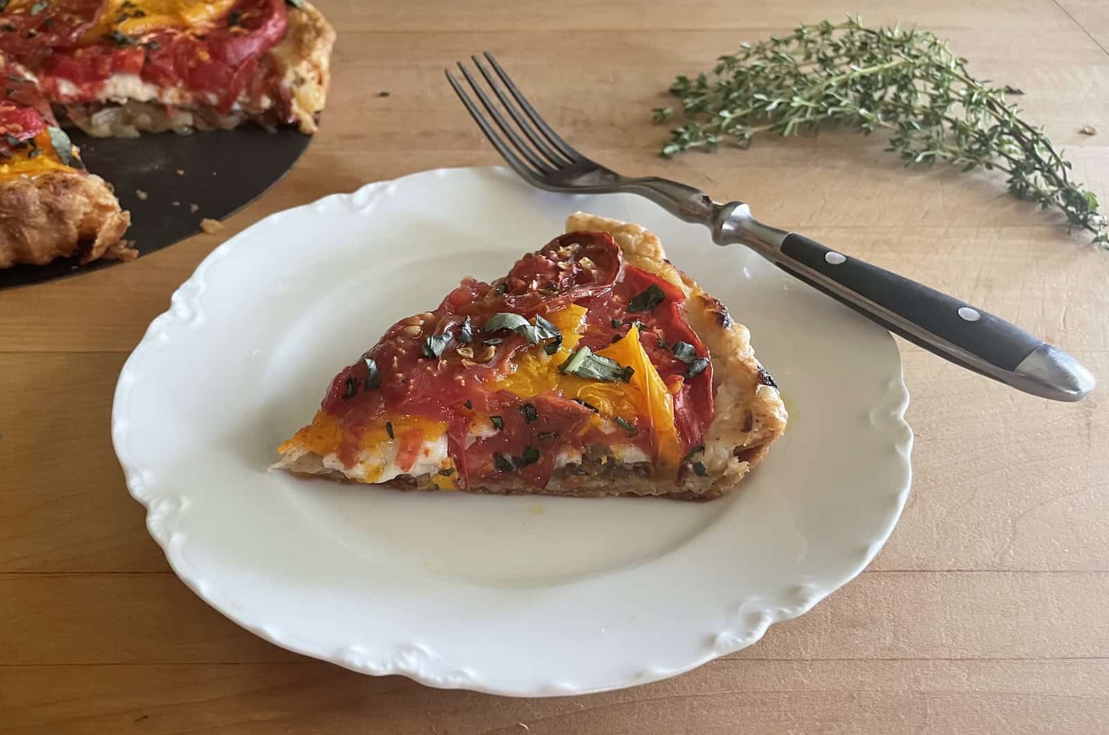 Tomato, Onion and Gruyere Tart slice on a plate