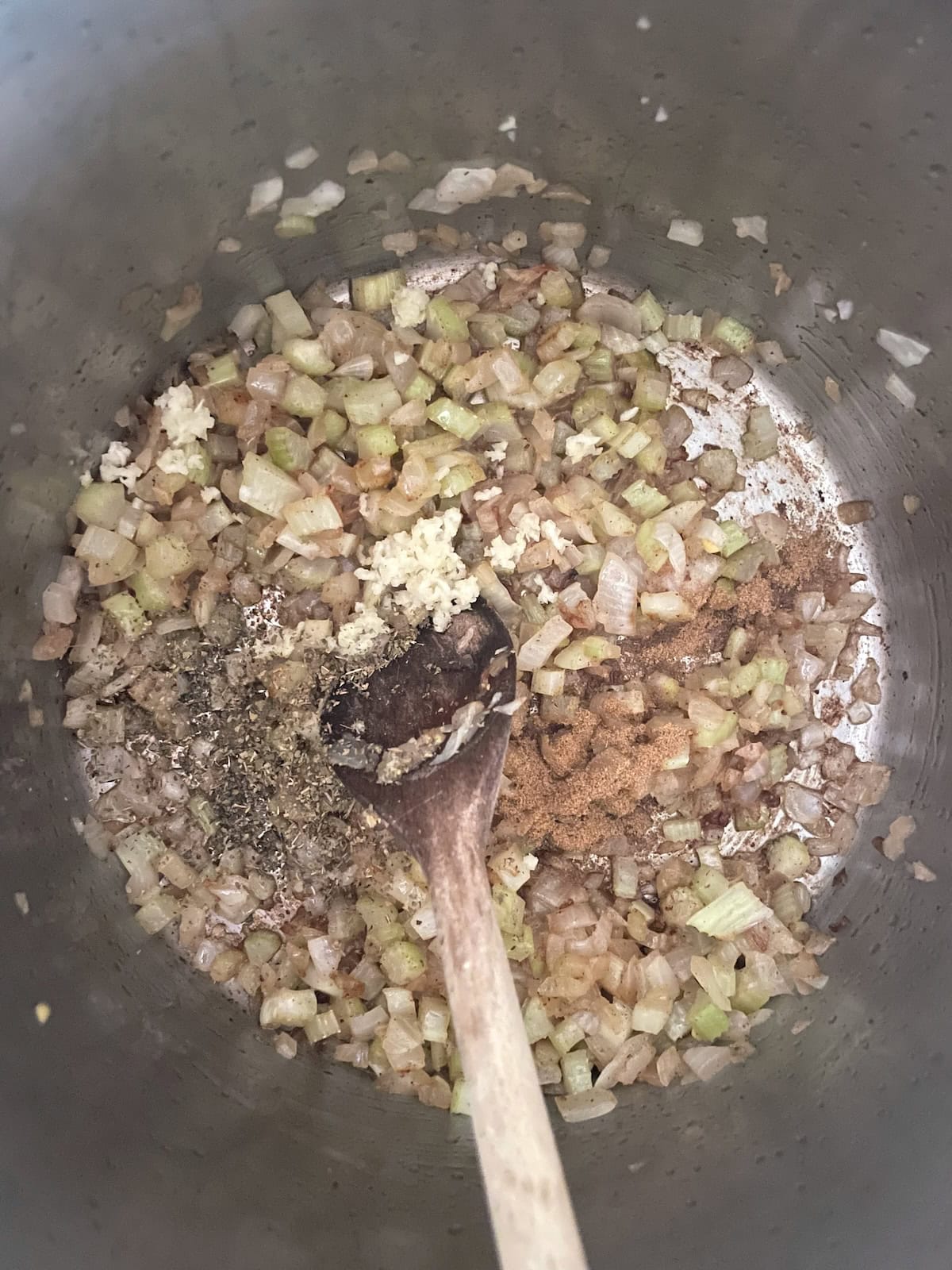 Adding spices to onions and celery