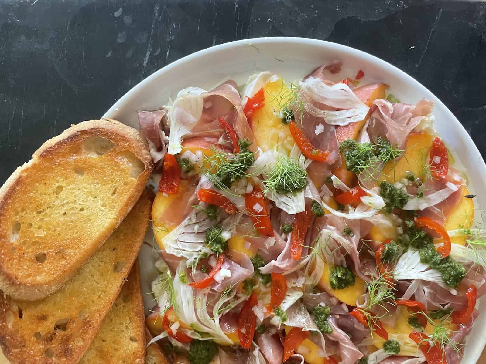 Peach Bruschetta with Burrata, Prosciutto and Arugula Oil