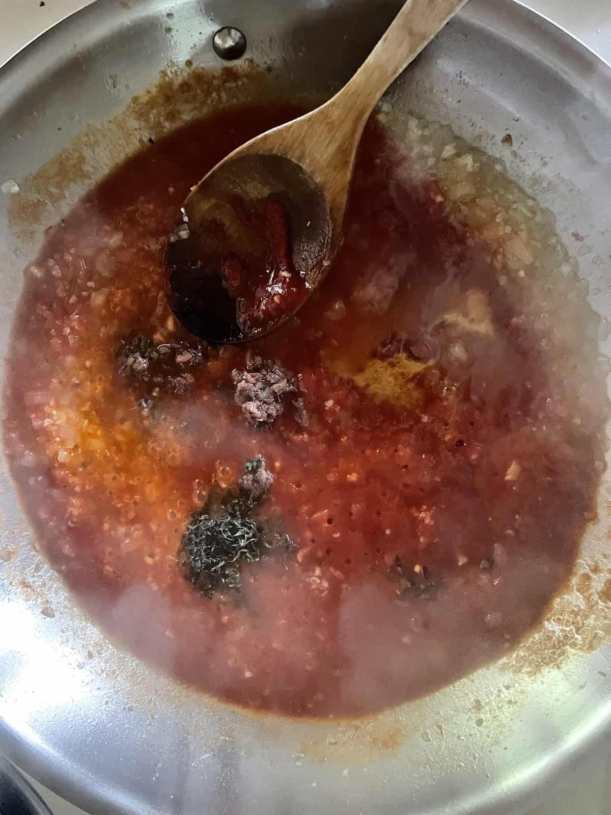 add tomato paste and herbs