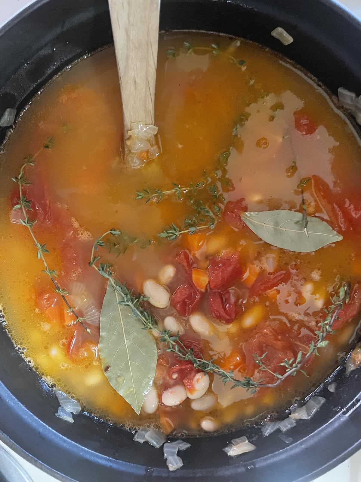 add chicken stock and herbs