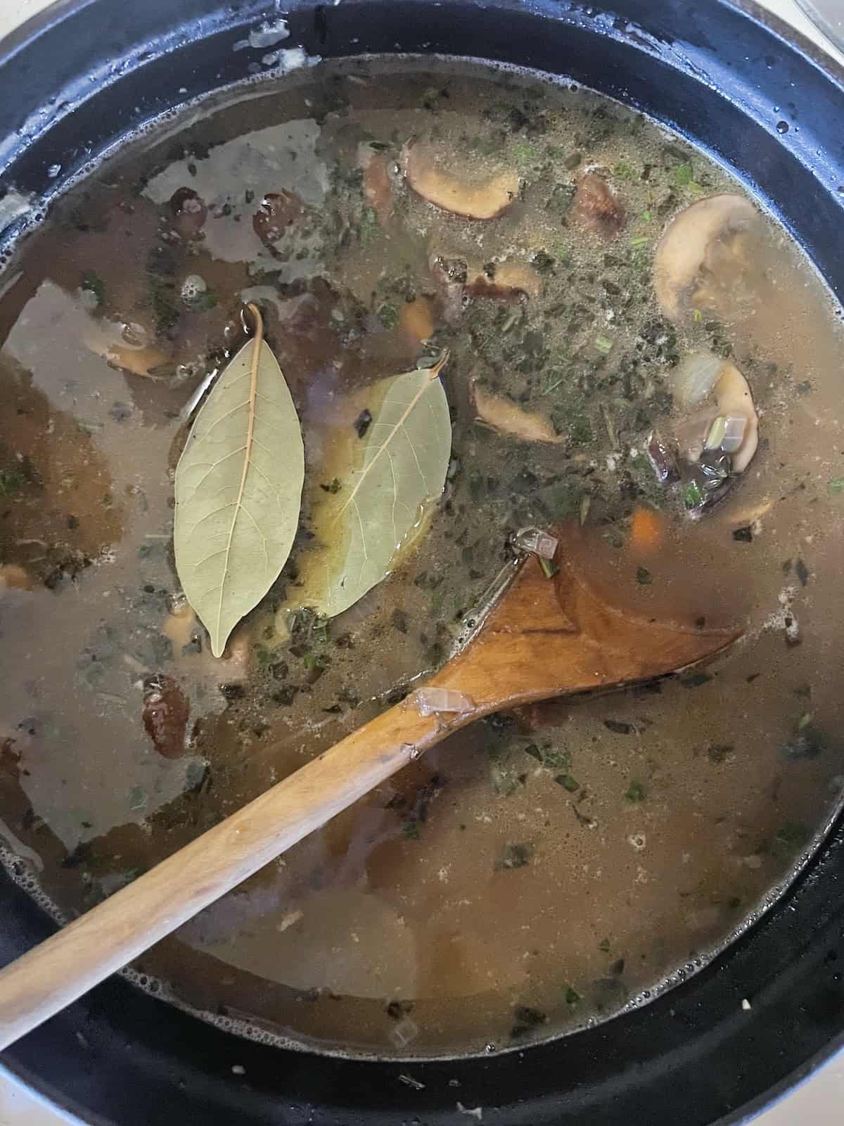 add chicken broth and bay leaves