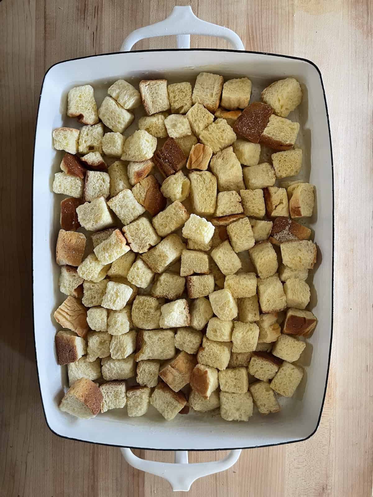 Place bread cubes in the baking dish.