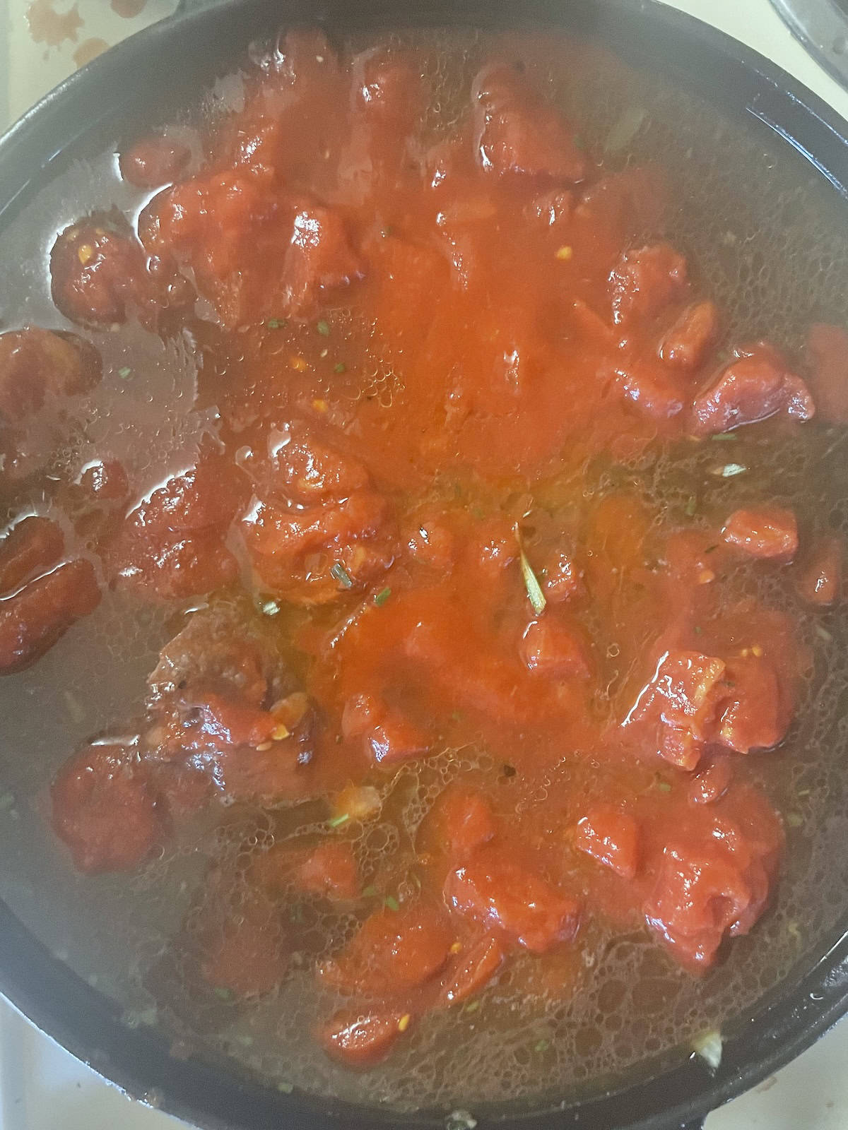 adding tomatoes to pot