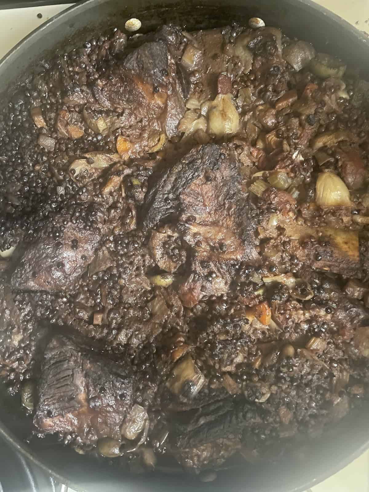 Braised Short Ribs and Lentils with Fennel, Olives and Artichokes finished