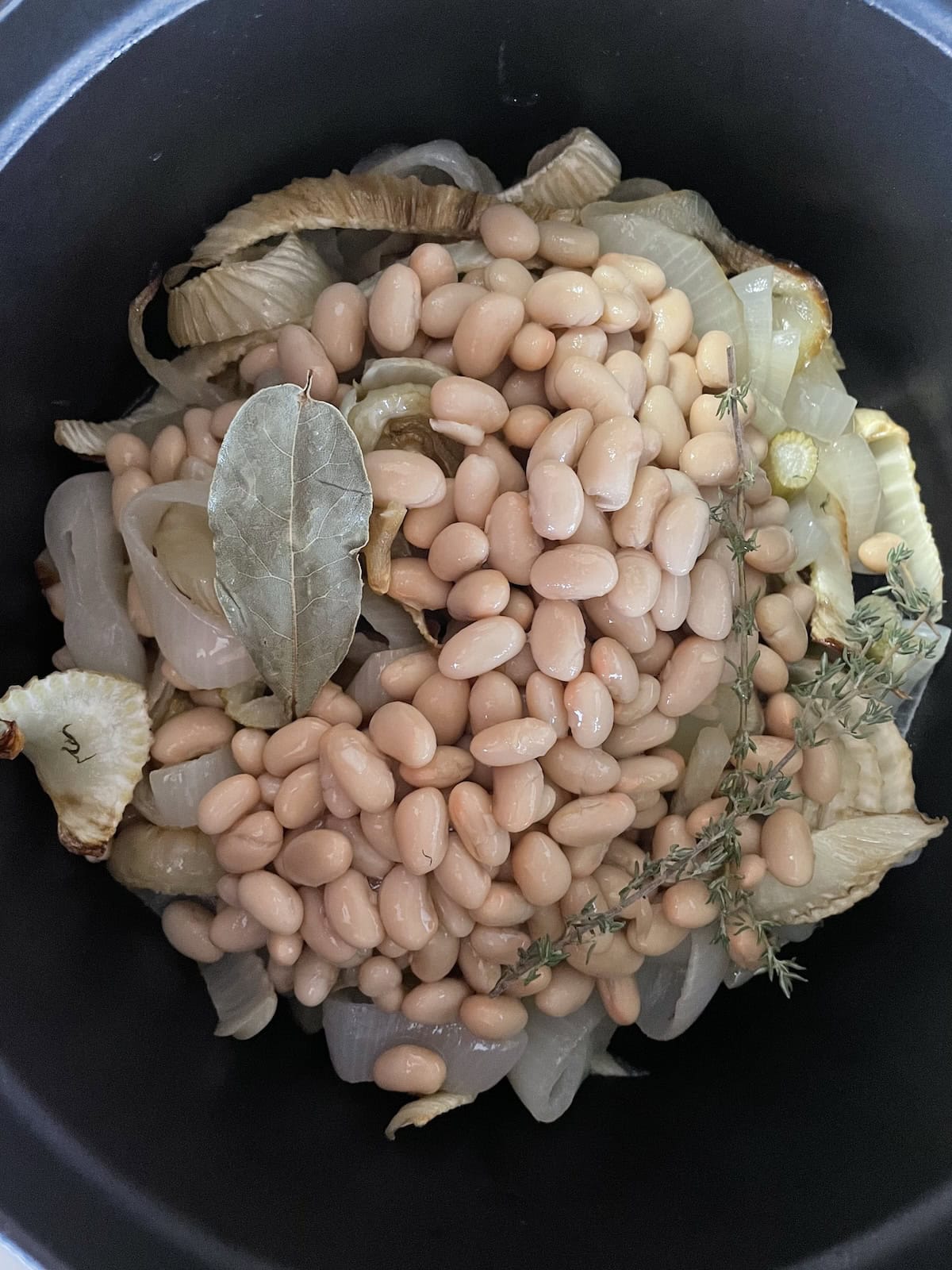 add beans and herbs to soup pot