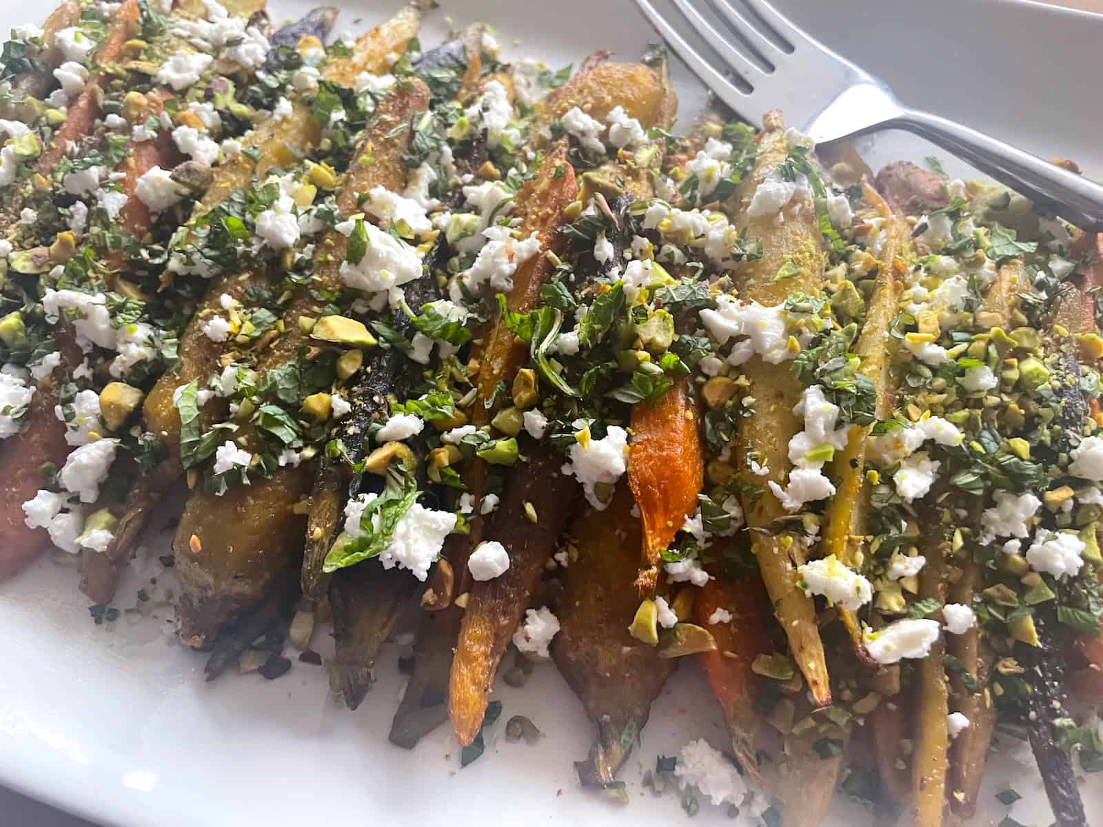 Harissa and Honey Carrots with Feta and Pistachios on a serving platter